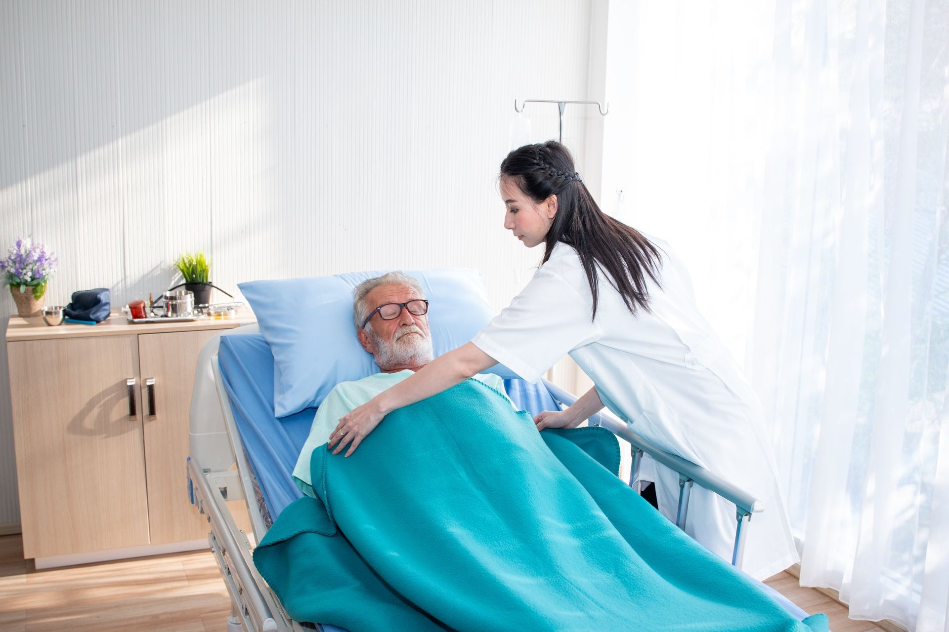 a old man or patient or elder sleeping on bed in hospital with doctor or nurse to take care and holding hands as health caring